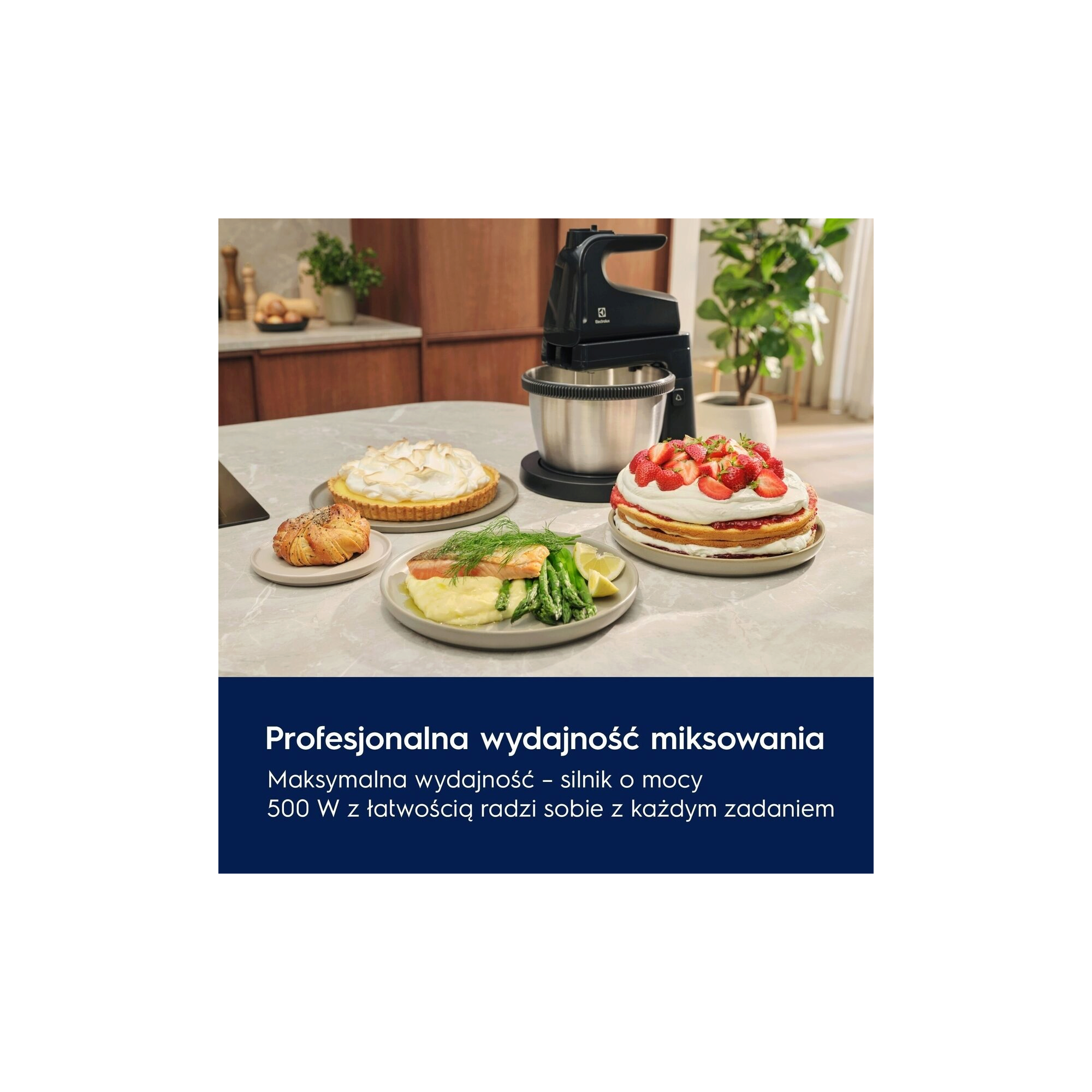 A black mixer with a bowl next to various delicious looking dishes on a table