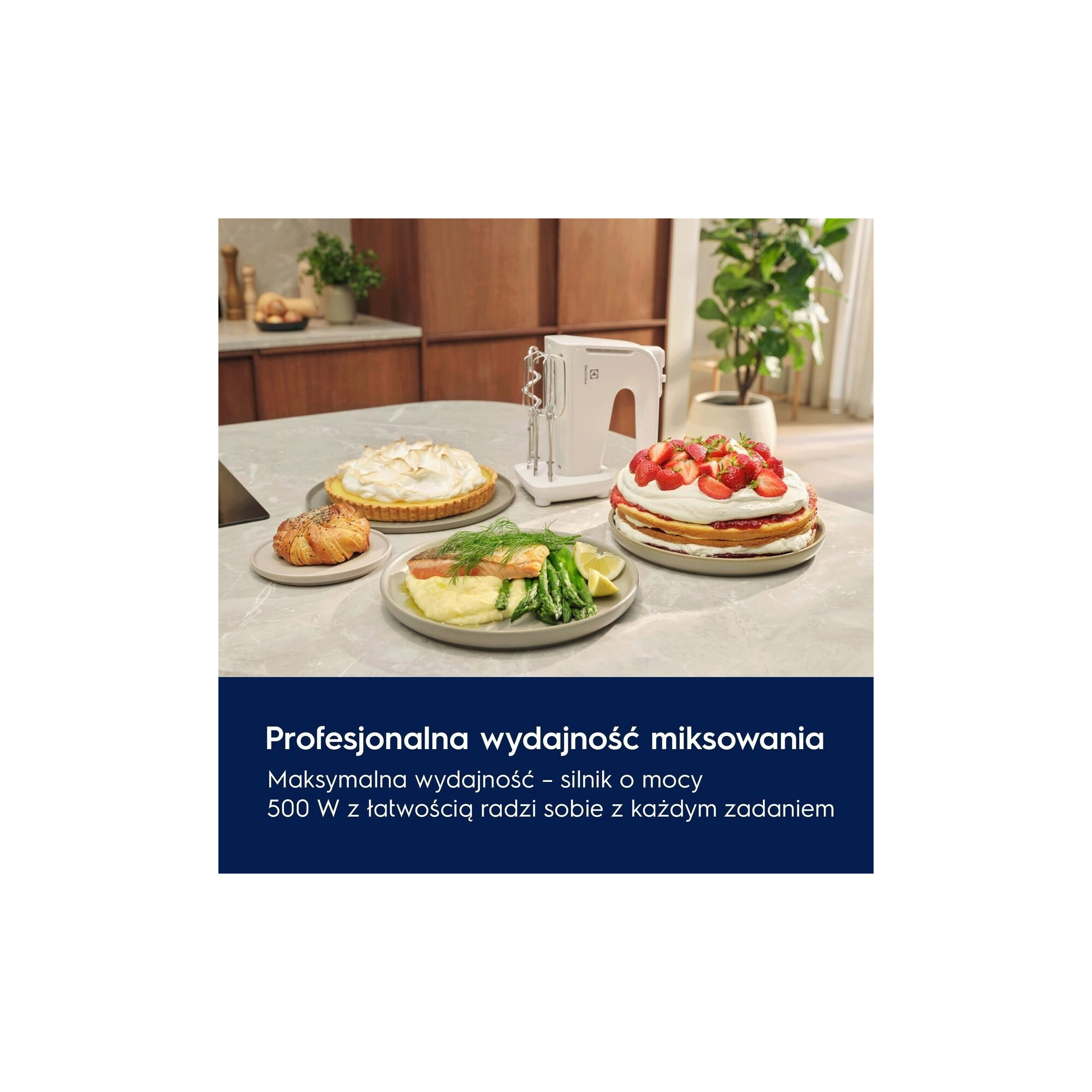 A white hand mixer next to various delicious looking dishes on a table