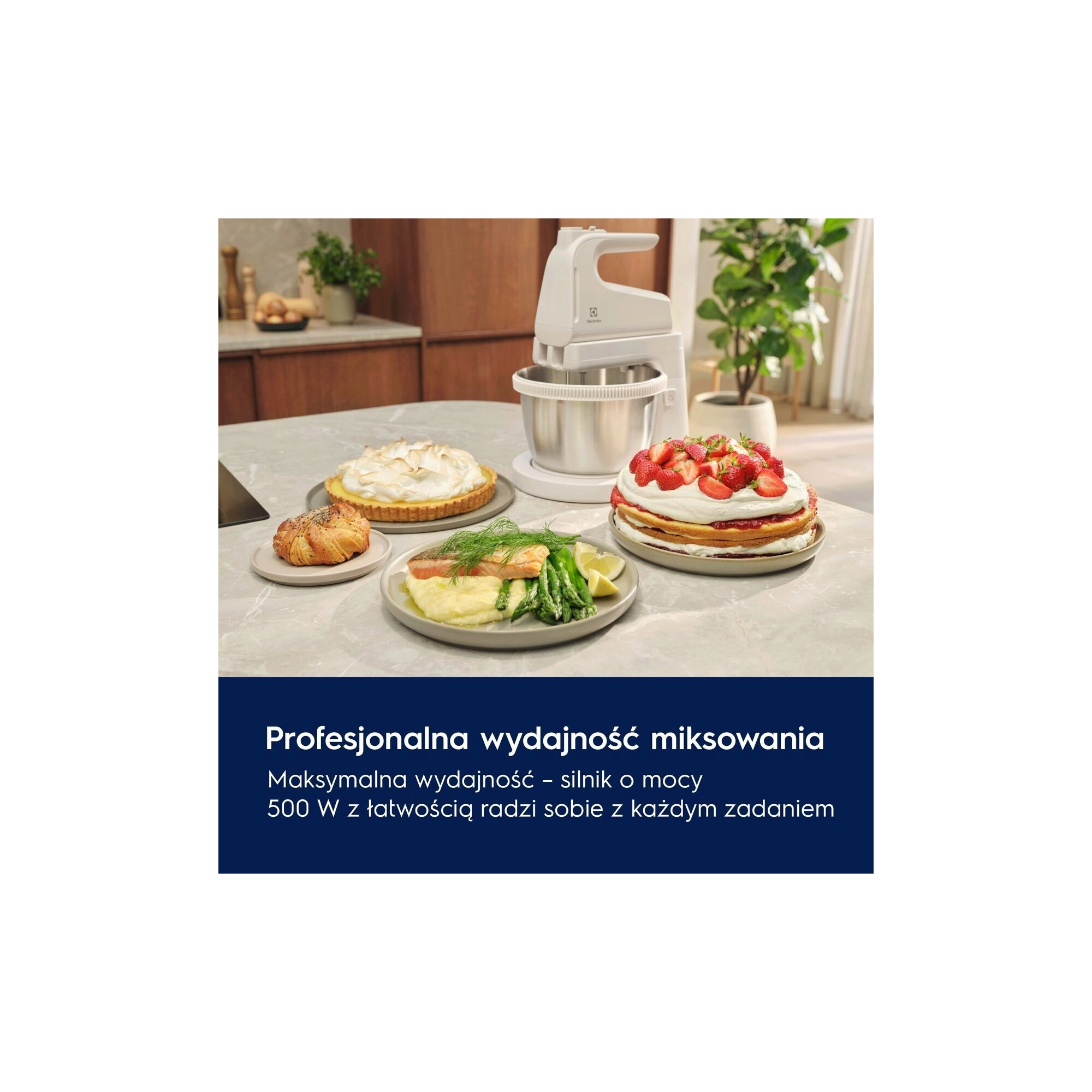 A white mixer with a bowl next to various delicious looking dishes on a table