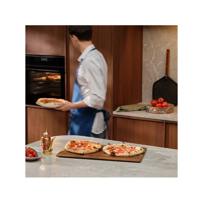 Person with the pizza expert oven and Neapolitan pizzas 