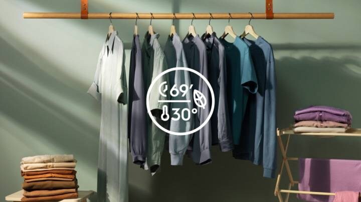 Symbol prania 30 stopni i ubrania w tle